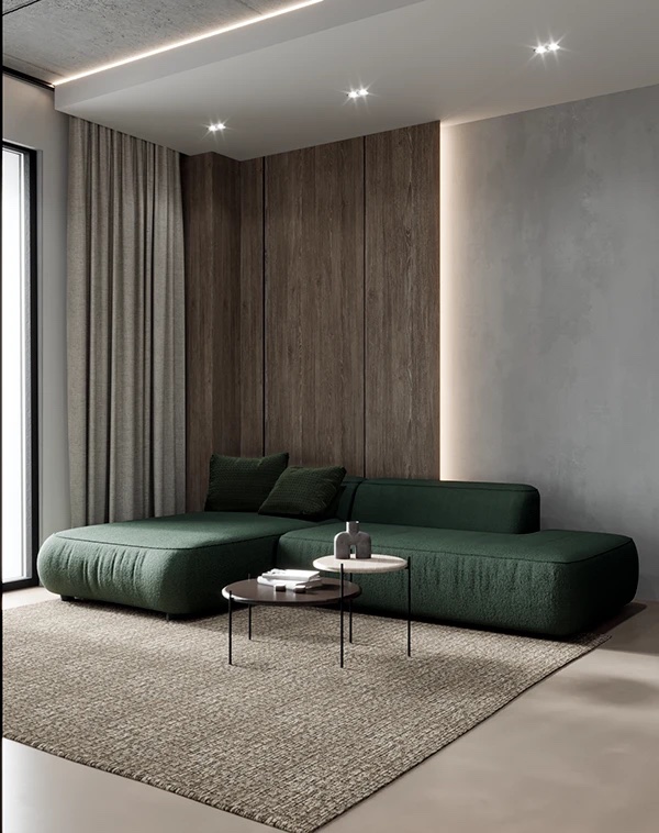 Угол гостиной, темно-зеленый угловой диван, за ним панель под темное дерево, серые шторы, панорамное окно, двойной журнальный столик, ковер на полу