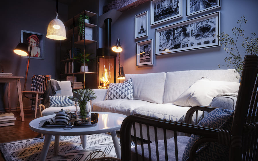 Уютная гостиная, диван, кресла, круглый журнальный стол с подносом и живыми цветами в вазе, книги на этажерке и на полу, рабочий стол, торшеры, камин