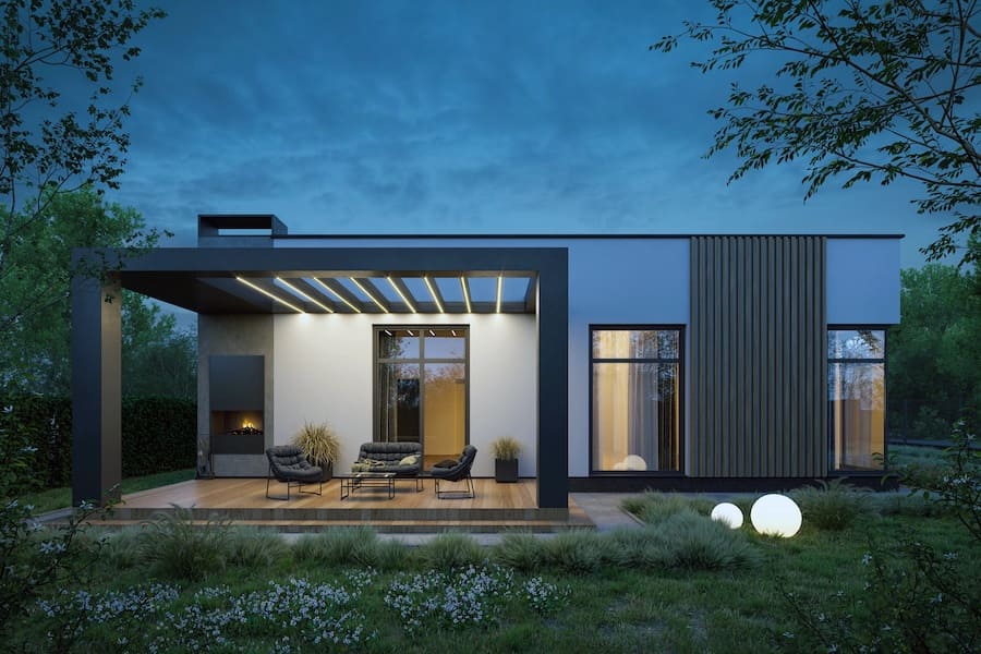 Одноэтажный дом в современном стиле, терасса, кресла, стол, камин, кашпо со злаками, цветник из многолетников, круглые грунтовые светильники