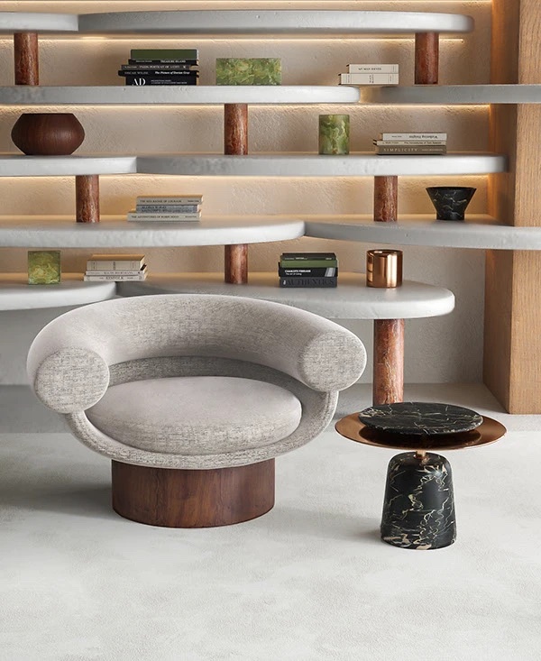 Гостиная, низкое полукруглое кресло, стелаж с закругленными полками, журнальный стол из камня и металла, книги и арт объекты из камня